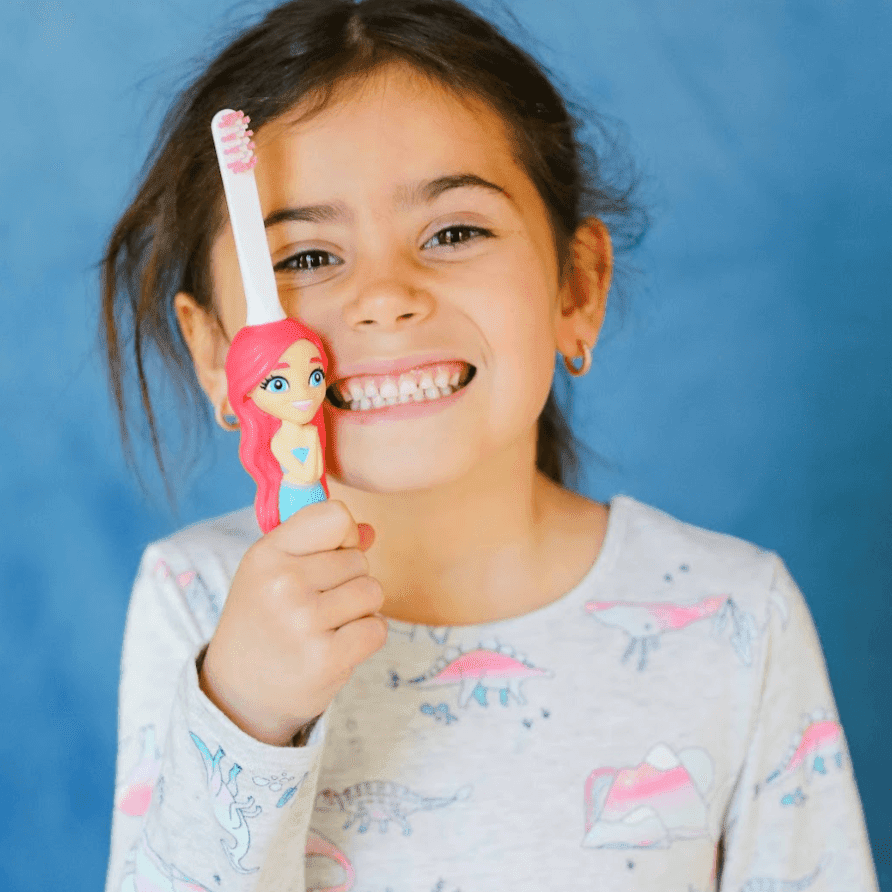 Child holding Aqua the Mermaid themed toothbrush