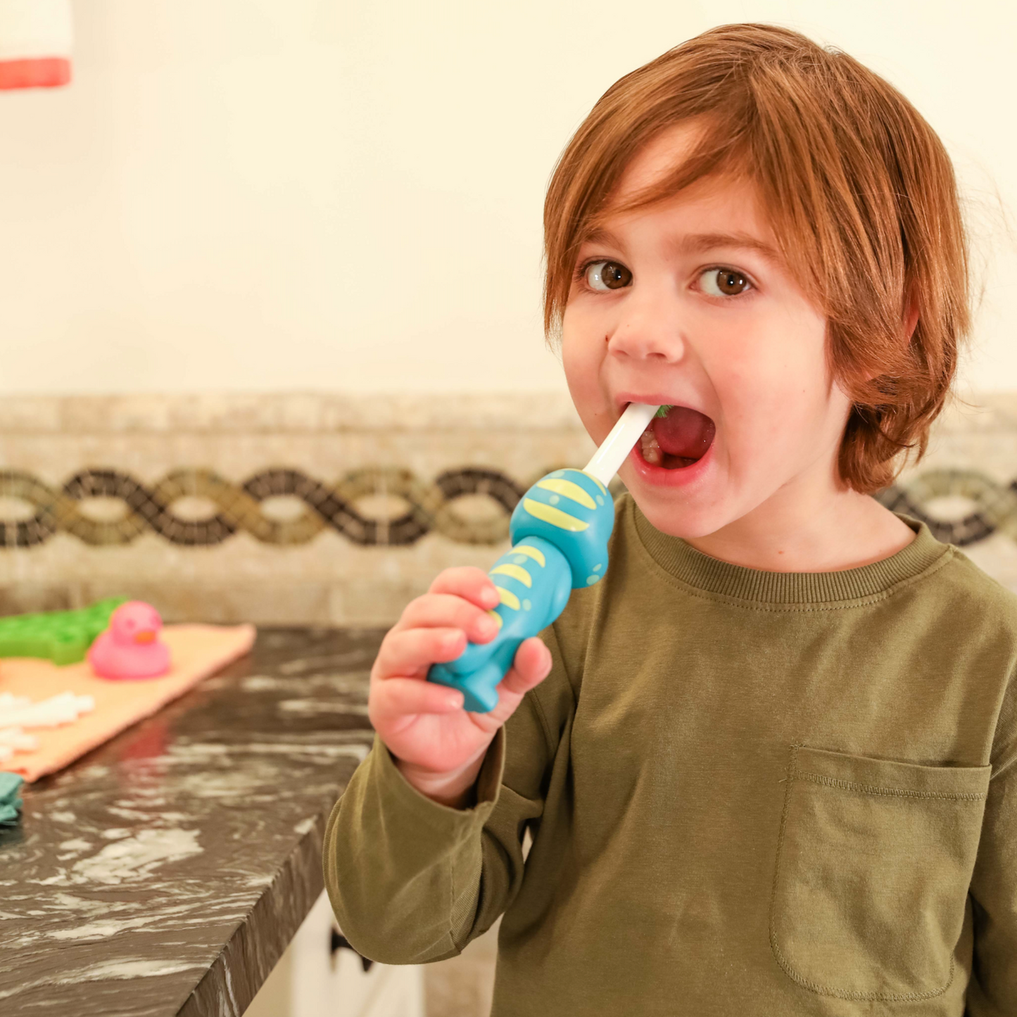 A child using Brushy the Brushasaurus 
