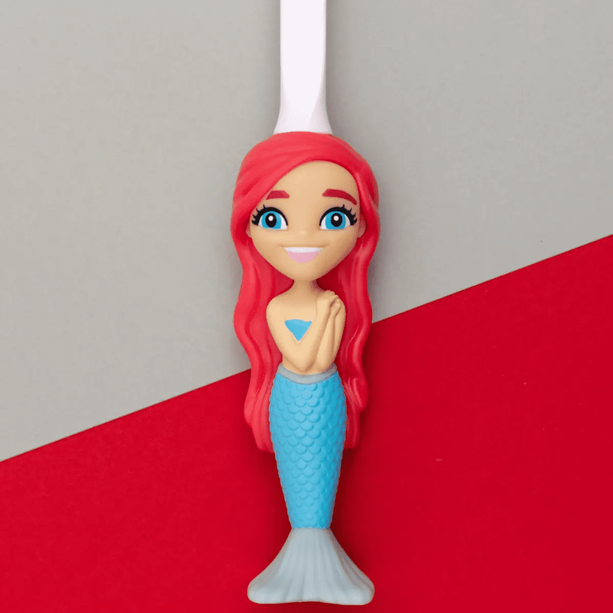 Aqua the Mermaid toothbrush featuring red-haired mermaid design