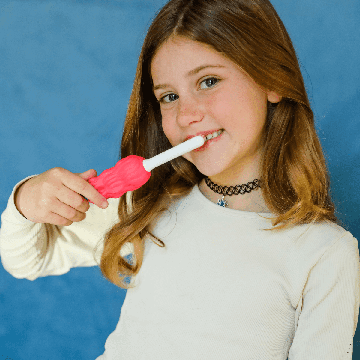 Young girl brushing her teeth using Aqua the Mermaid toothbrush