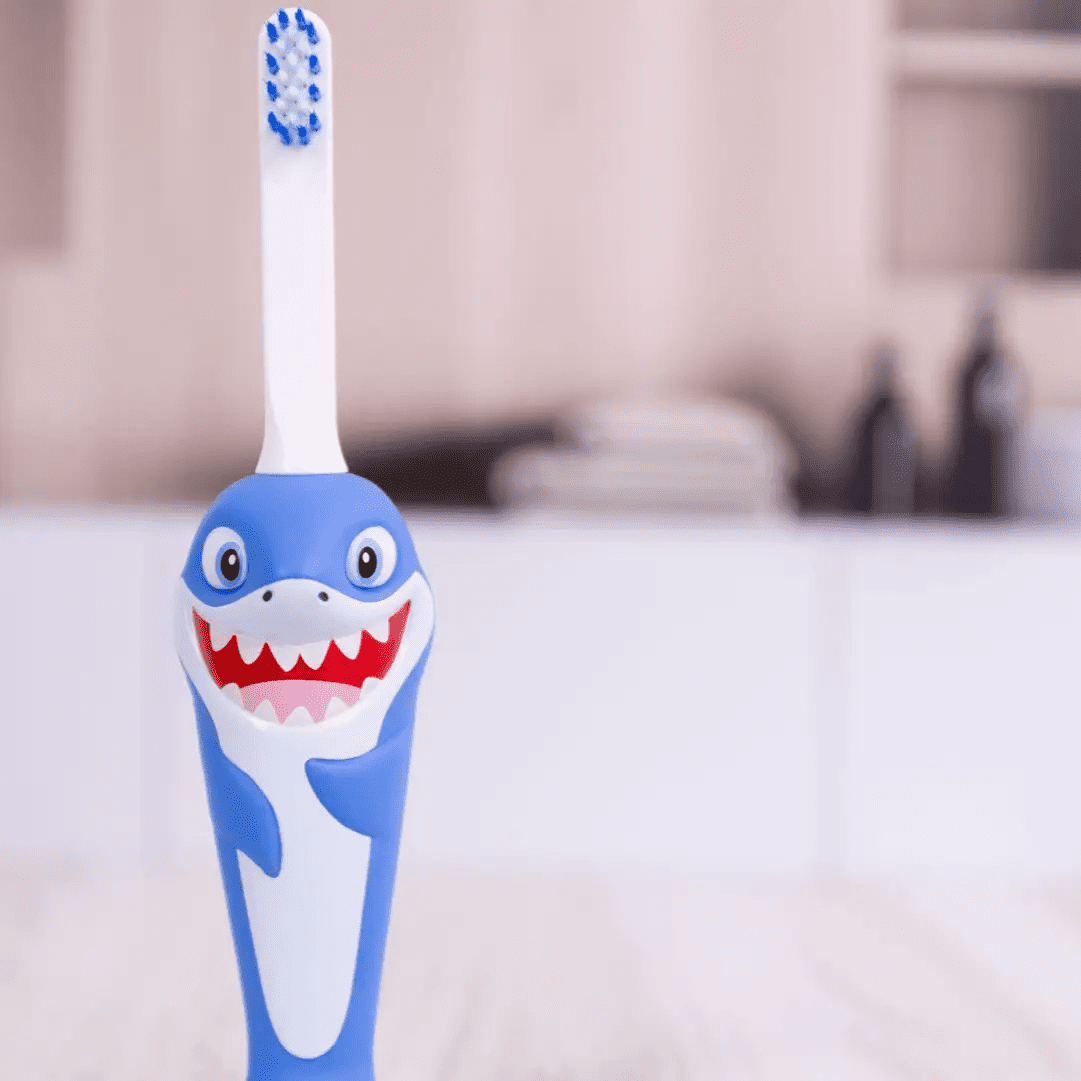Close-up view of Chompers the Shark themed toothbrush