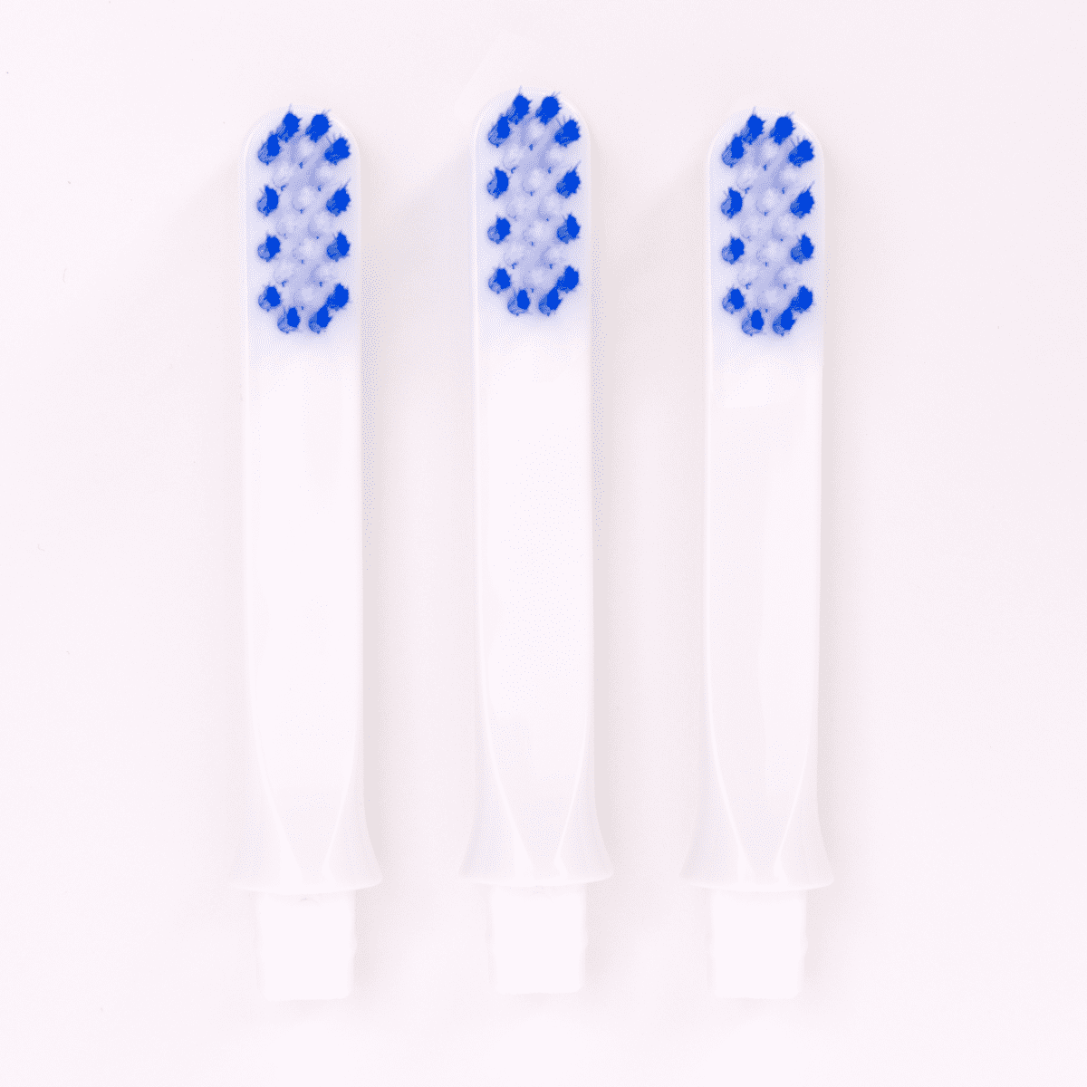Three replacement brushes with blue and white bristles