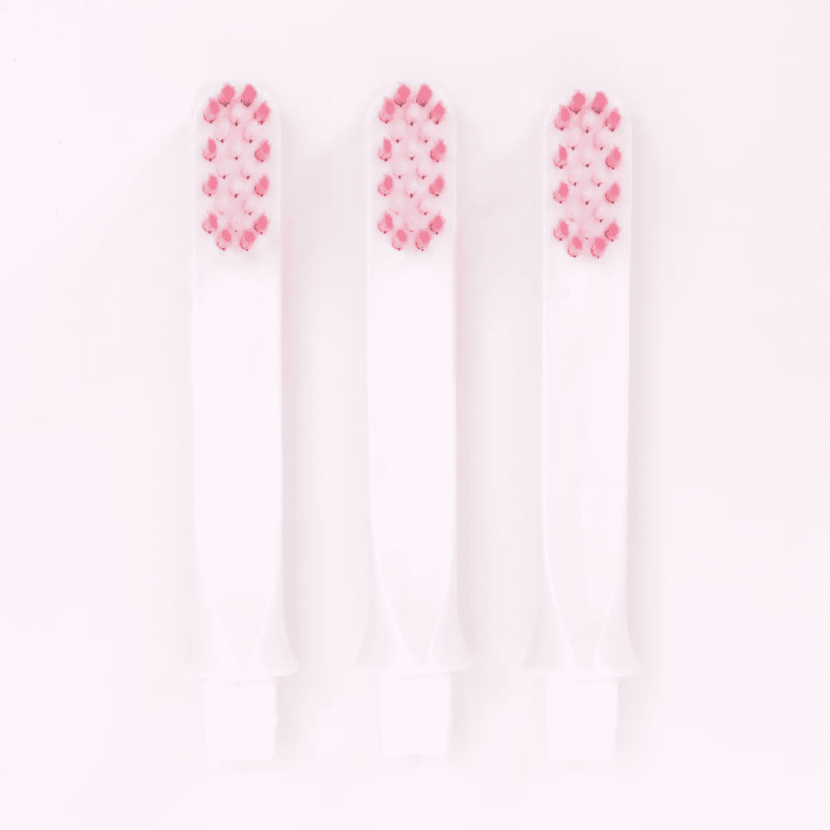 Three-pack replacement brushes with pink and white bristles